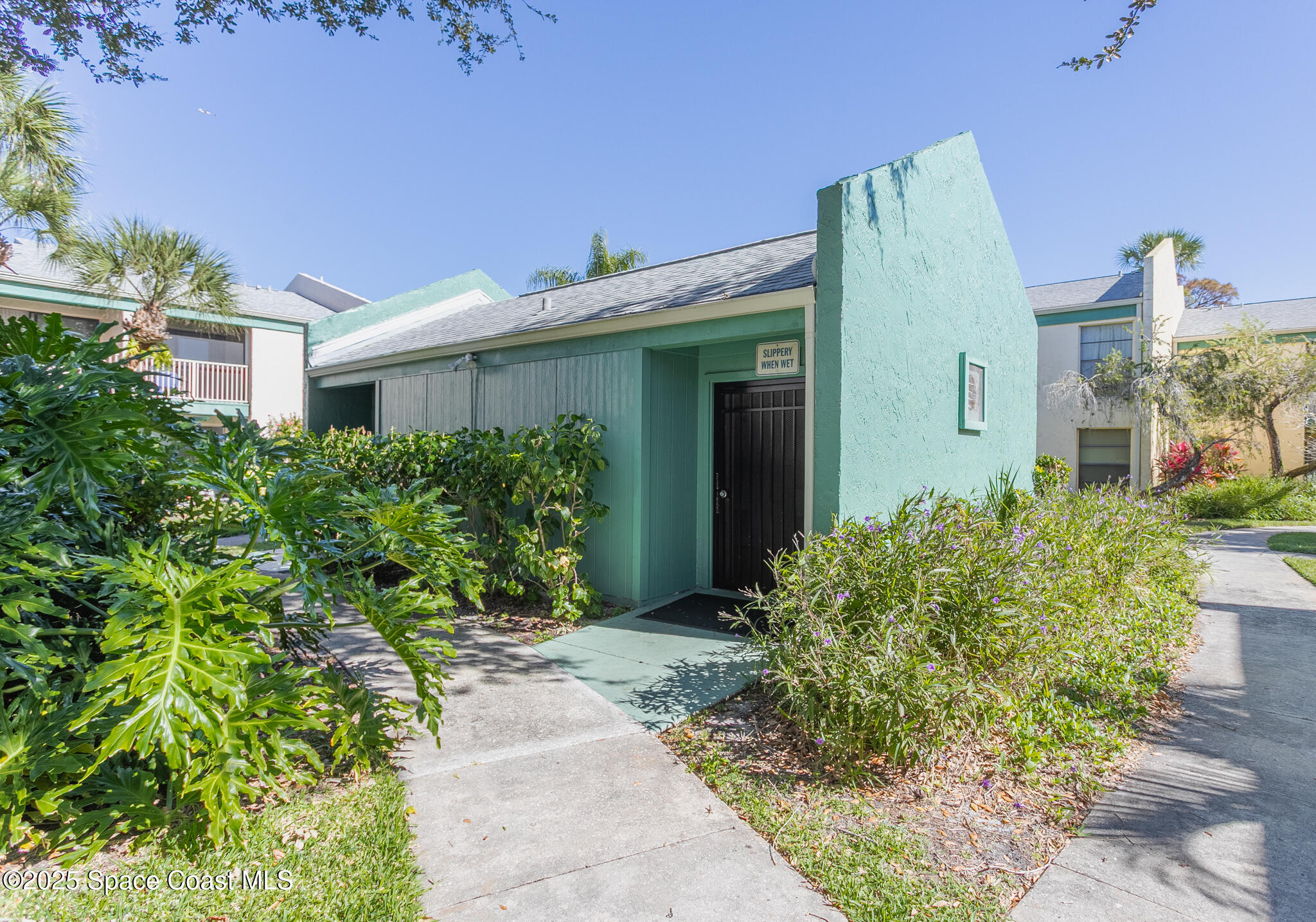 1225 North Wickham Road, Unit 712 Melbourne, FL 32935 - Photo 17 of 24 a front view of a house with garden