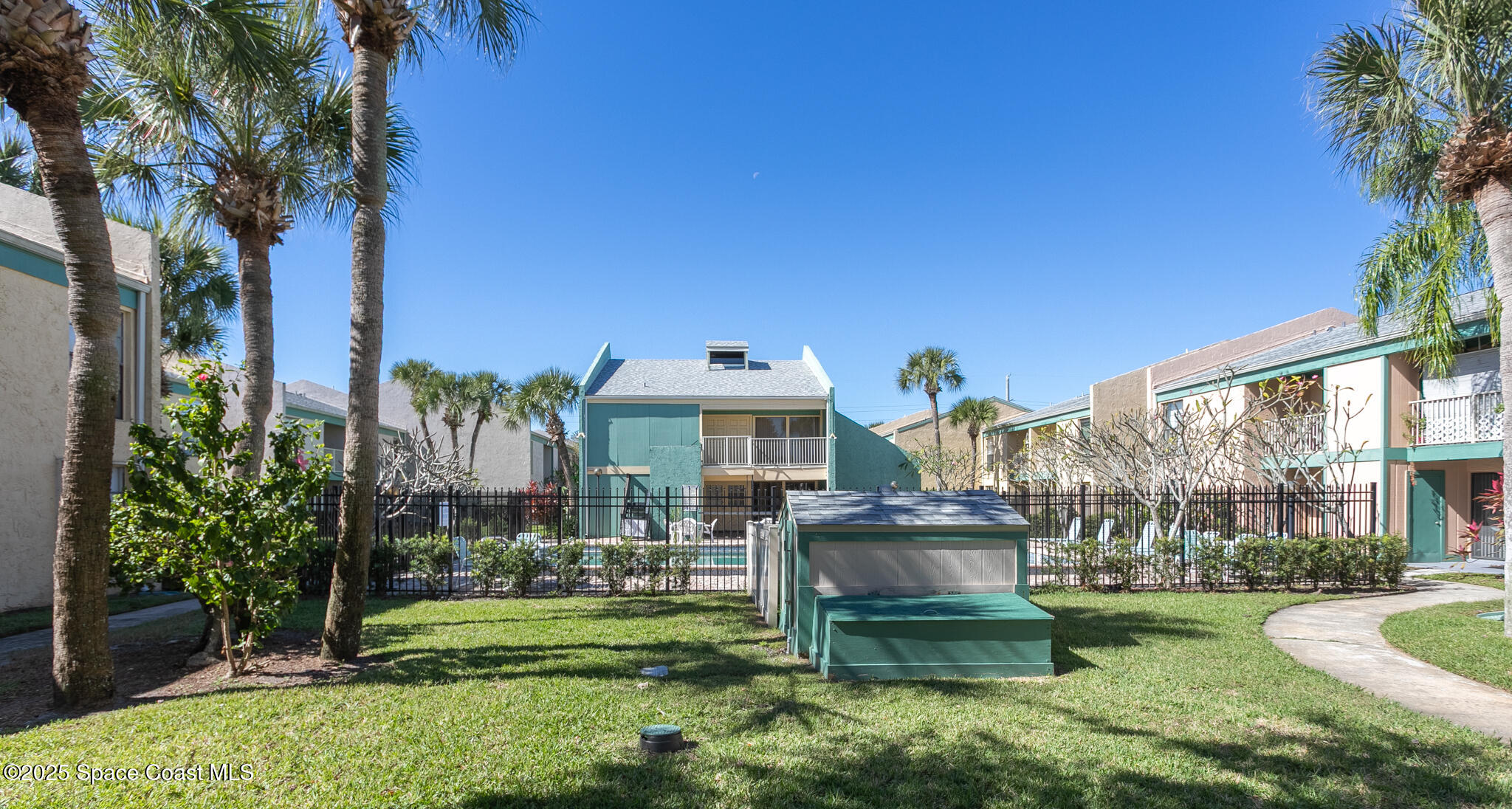 1225 North Wickham Road, Unit 712 Melbourne, FL 32935 - Photo 21 of 24 a front view of a house with a yard