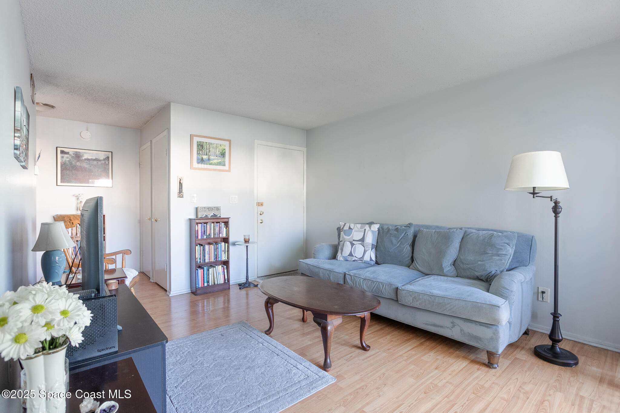 1225 North Wickham Road, Unit 712 Melbourne, FL 32935 - Photo 5 of 24 a living room with furniture and a wooden floor