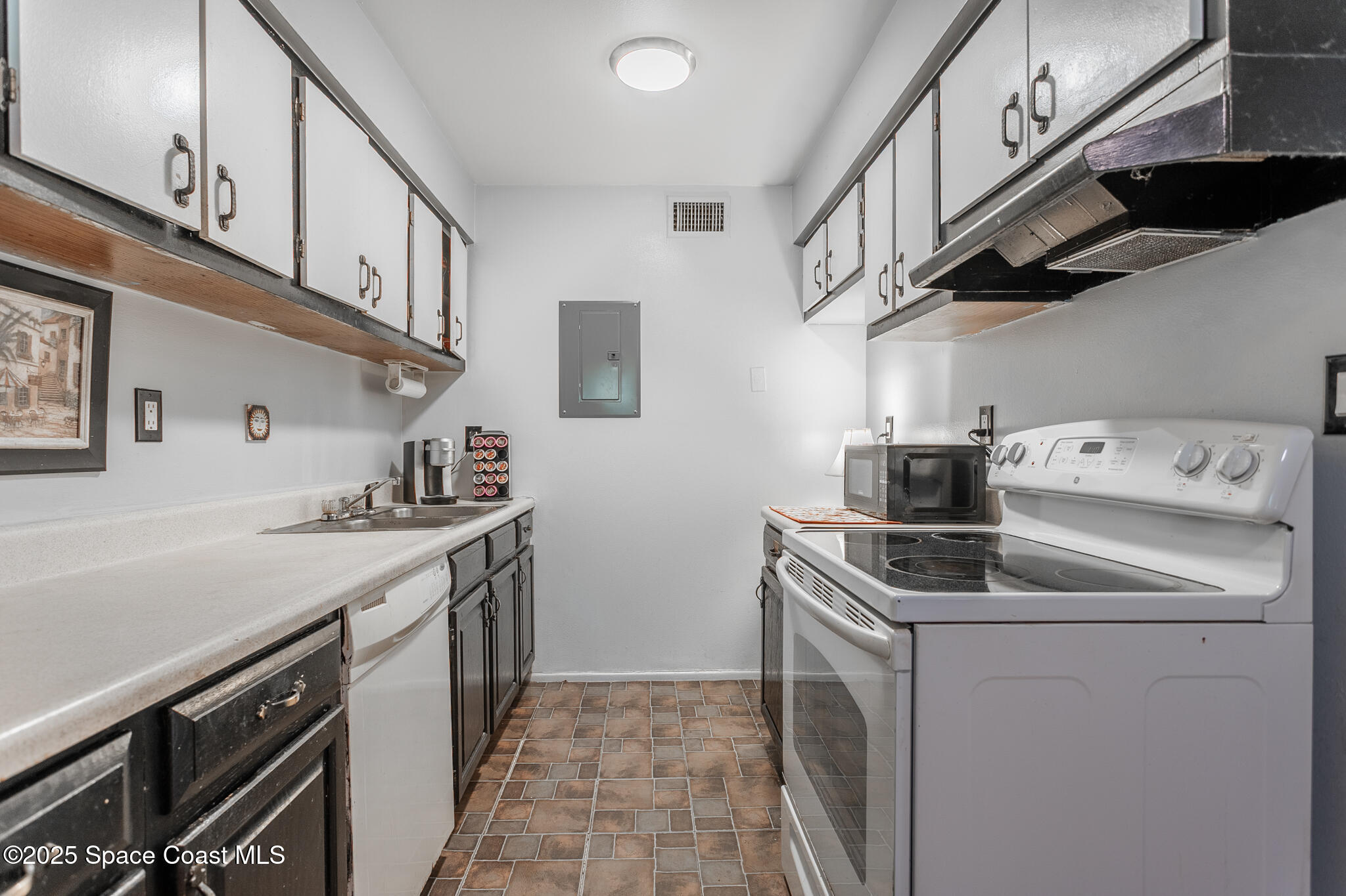 1225 North Wickham Road, Unit 712 Melbourne, FL 32935 - Photo 8 of 24 a utility room with stainless steel appliances granite countertop a sink and a stove