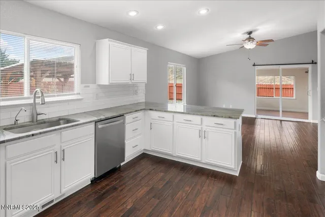 a kitchen with a sink cabinets and wooden floor
