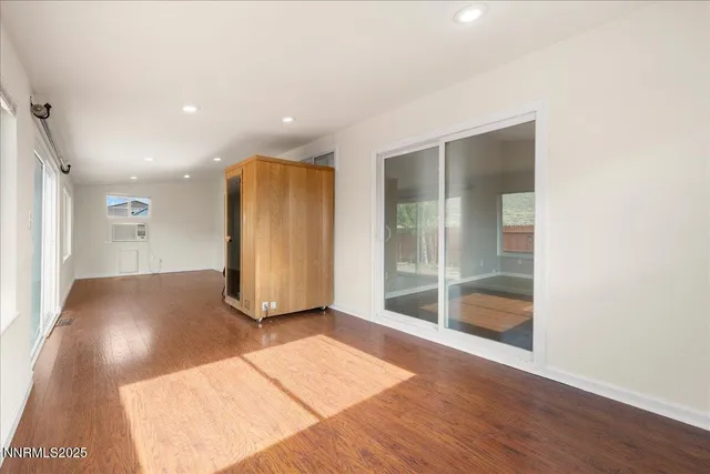 a view of a room with wooden floor