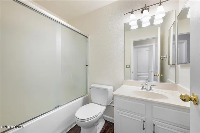 a bathroom with a sink vanity mirror and toilet
