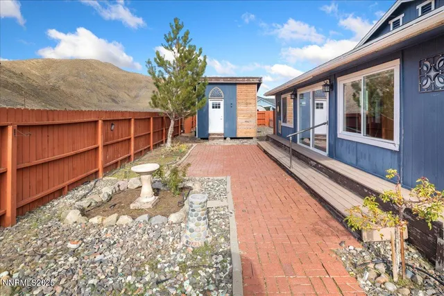 a view of a house with backyard and sitting area