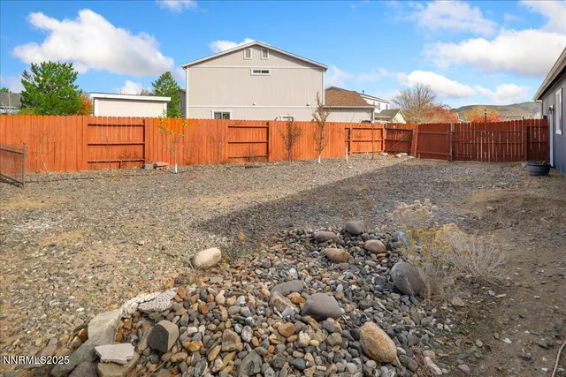 a backyard of a house with wooden fence