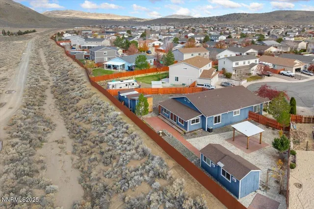 an aerial view of residential houses with outdoor space