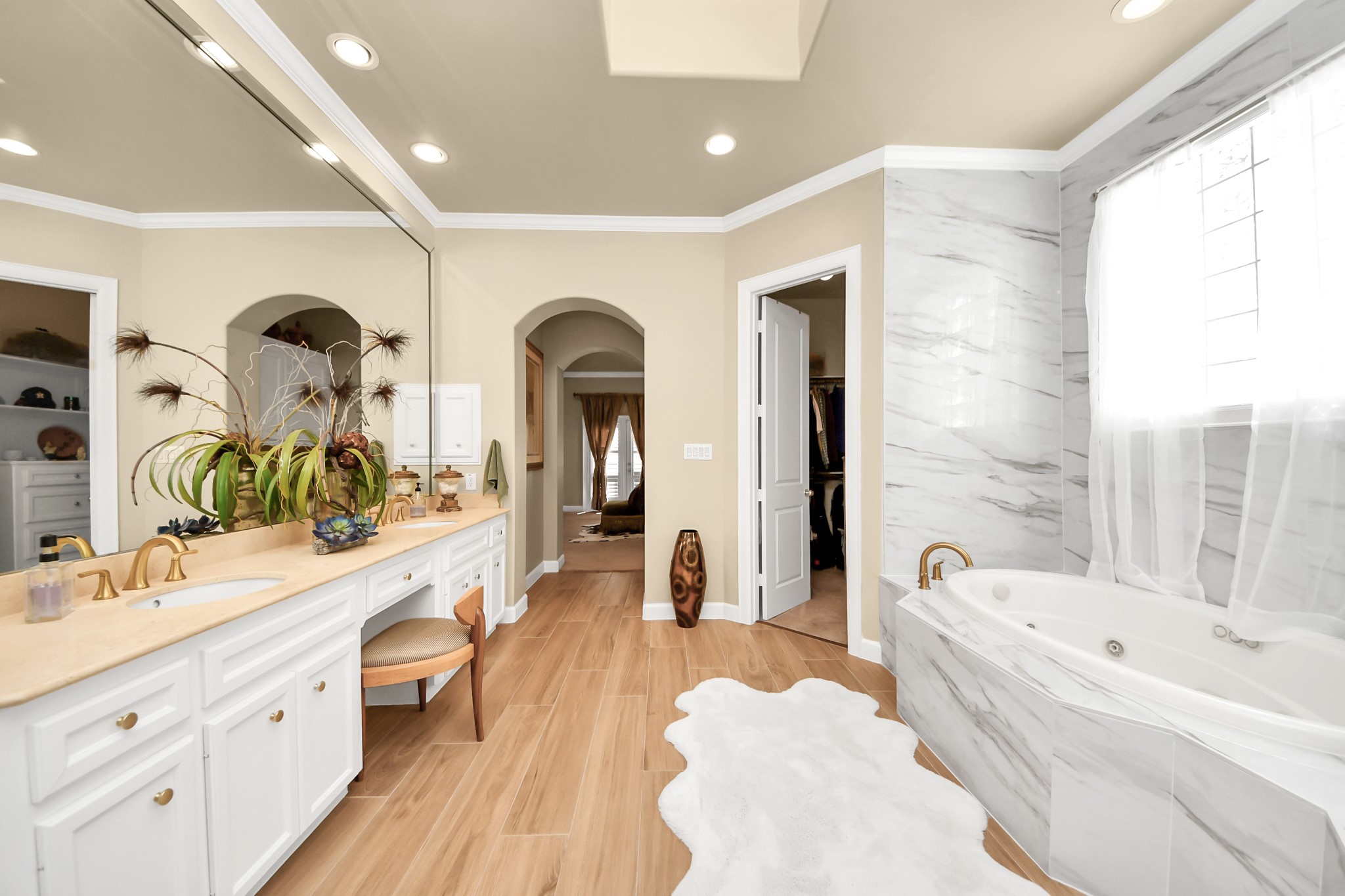 6302 Hermann Lake Drive Houston, TX 77021 - Photo 30 of 50 Elegant finishes, a spacious double vanity, and expansive mirrors create a bright and refined atmosphere.