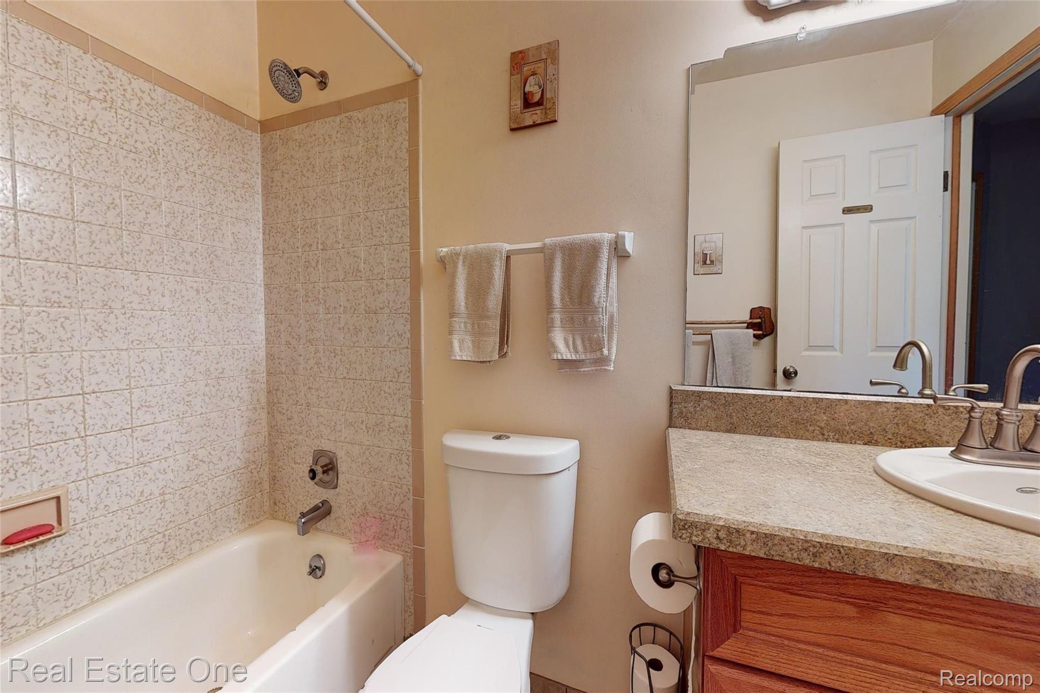 8120 Green Road Fenton, MI 48430 - Photo 28 of 46 First floor full bathroom. Brushed Nickle faucet, new toilet, tile floors.