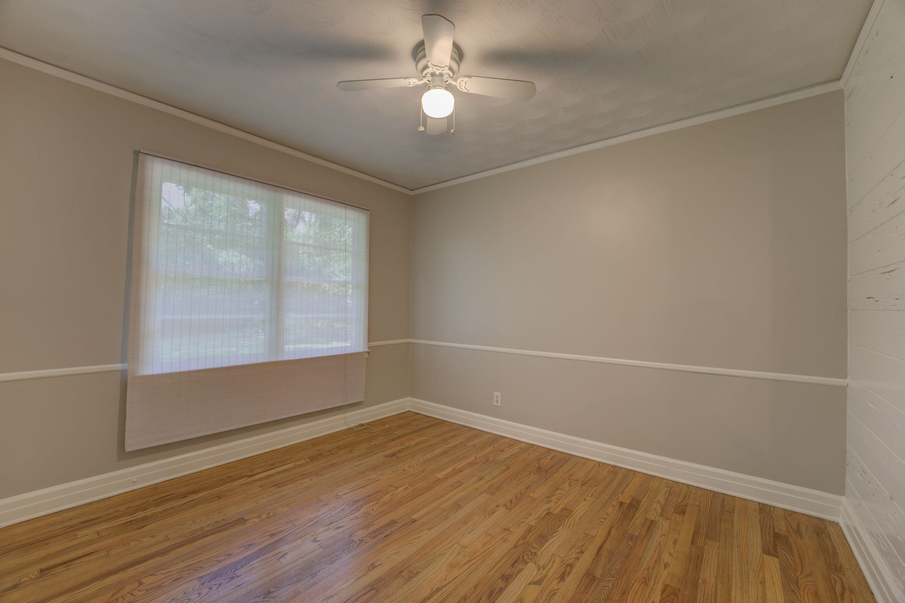 4708 Chip Road Memphis, TN 38117 - Photo 14 of 21 Unfurnished room featuring wood-type flooring, ornamental molding, and ceiling fan