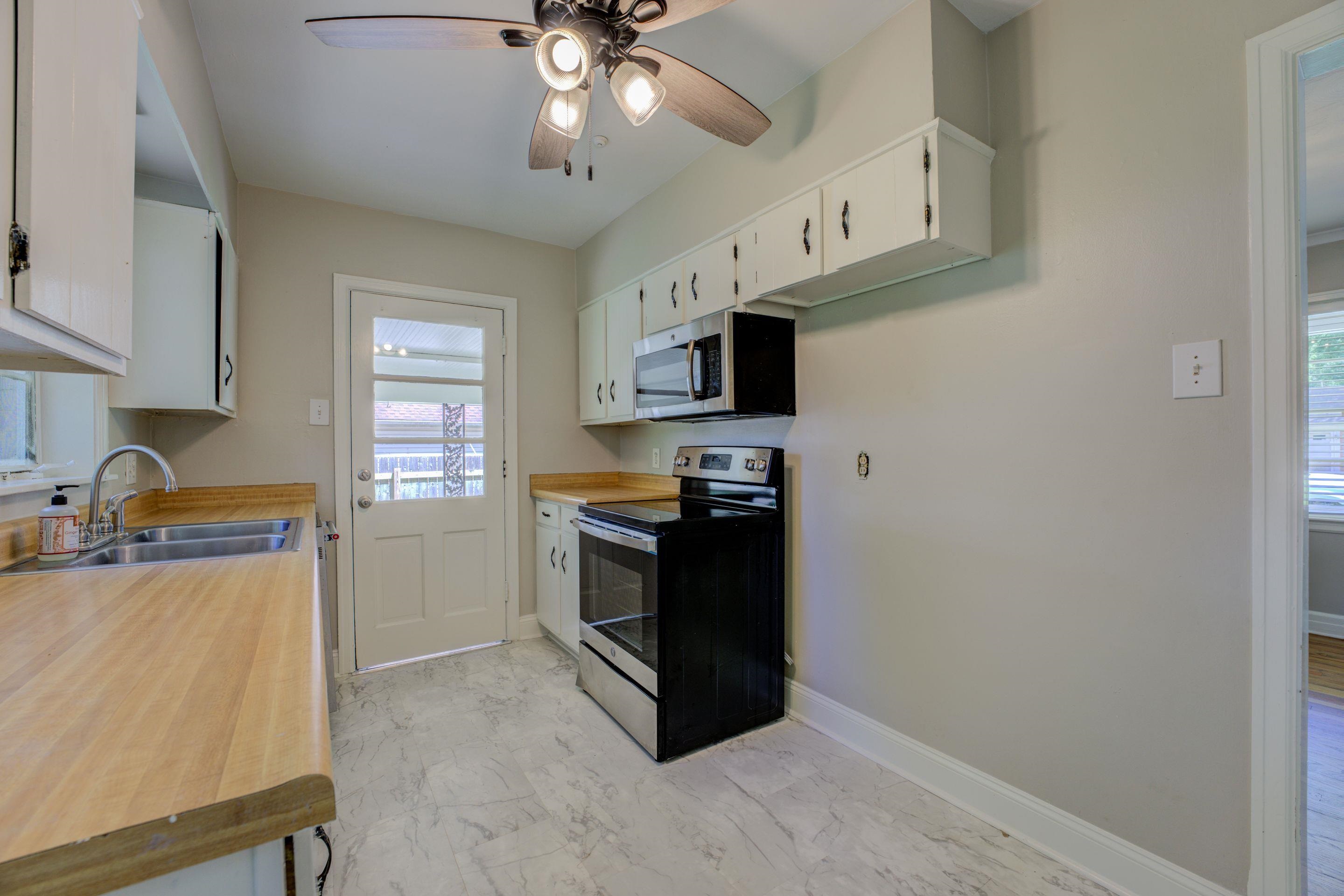 4708 Chip Road Memphis, TN 38117 - Photo 6 of 21 Kitchen featuring white cabinets, electric range, sink, and ceiling fan