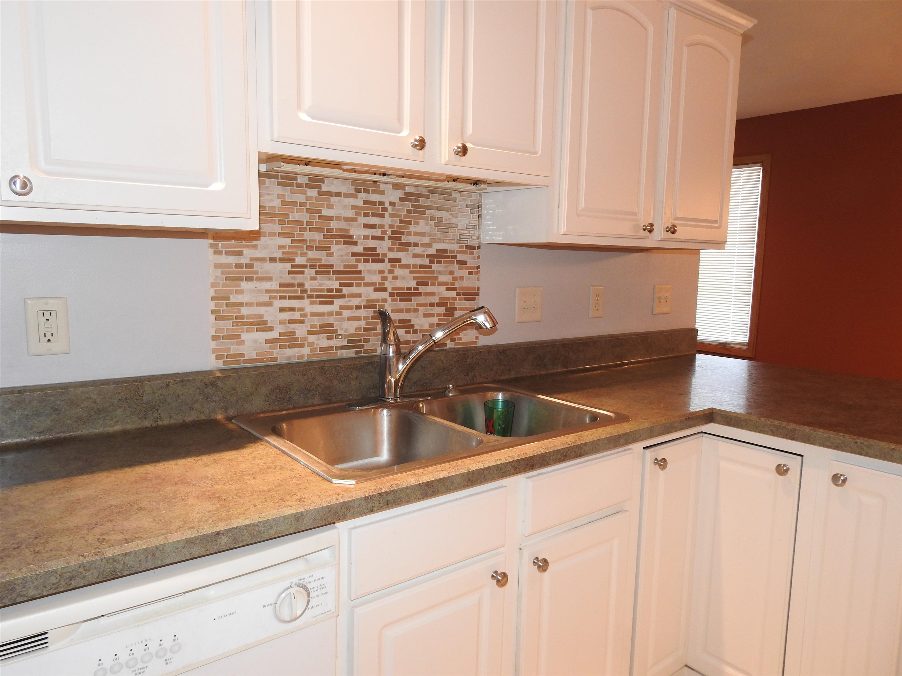 910 High Point Drive Rockton, IL 61072 - Photo 11 of 14 a kitchen with granite countertop a sink and cabinets