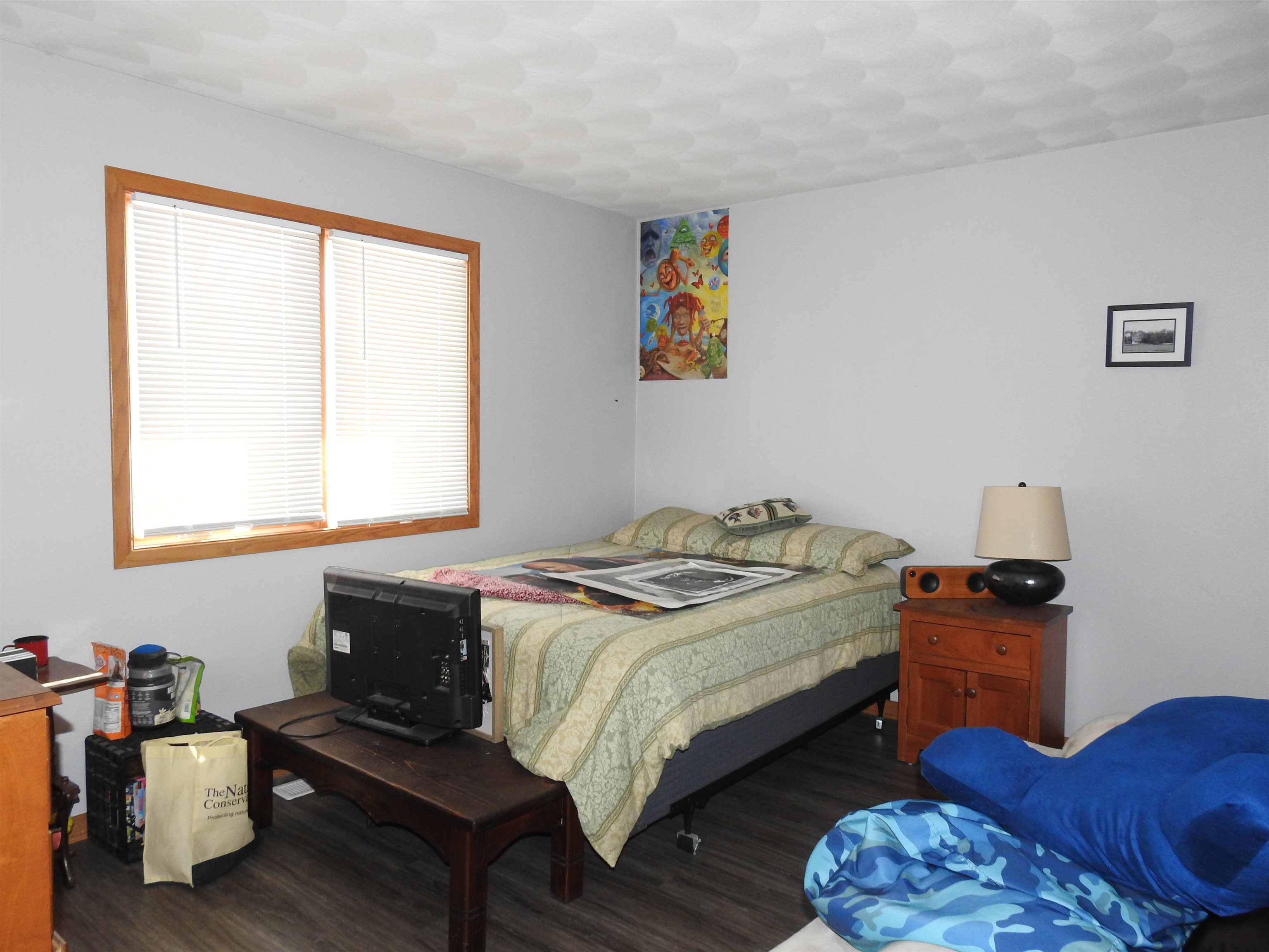 910 High Point Drive Rockton, IL 61072 - Photo 4 of 14 a bedroom with a bed and wooden floor