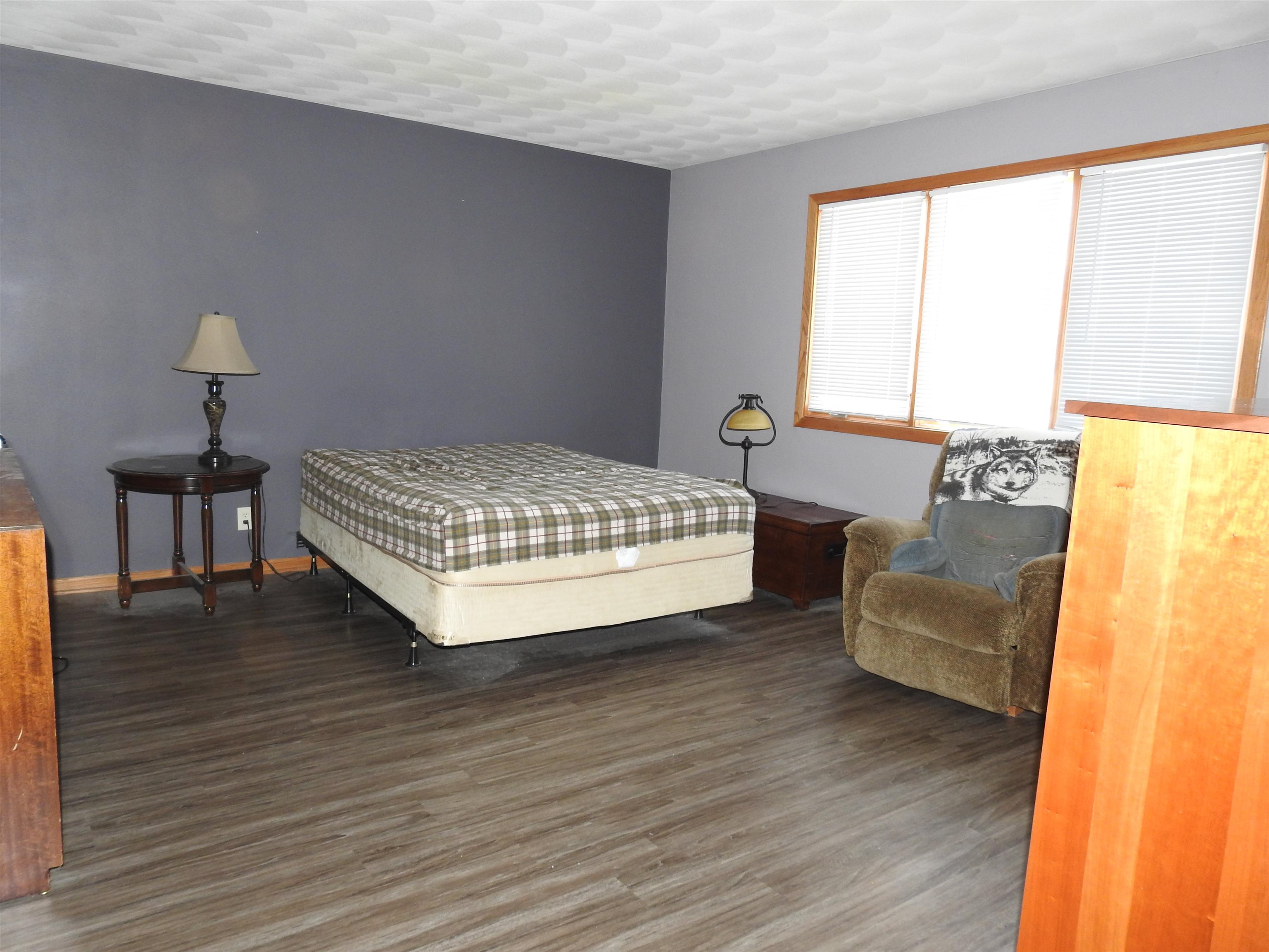 910 High Point Drive Rockton, IL 61072 - Photo 5 of 14 a bedroom with a bed and wooden floor