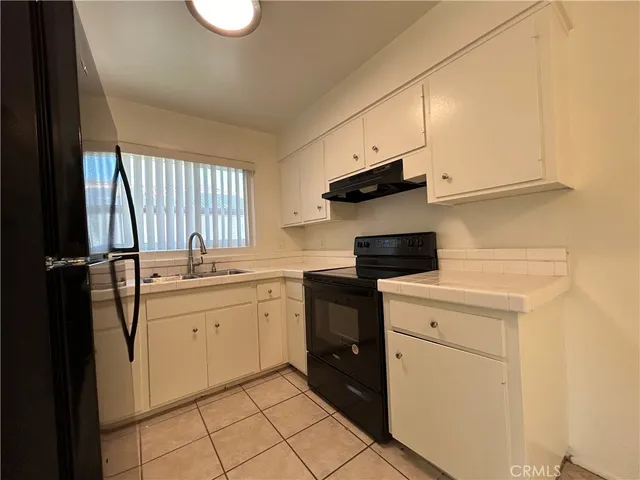 a kitchen with a sink cabinets and appliances