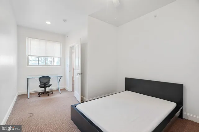 a living room with furniture and a ceiling fan