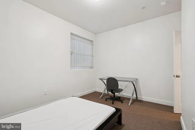 a utility room with a sink a toilet and a mirror