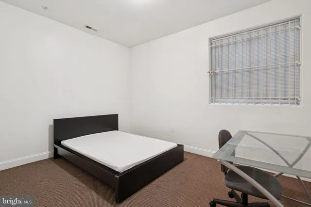 a bathroom with a granite countertop sink a toilet and bathtub