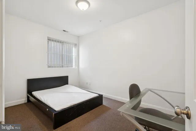 a bedroom with a bed and a chair