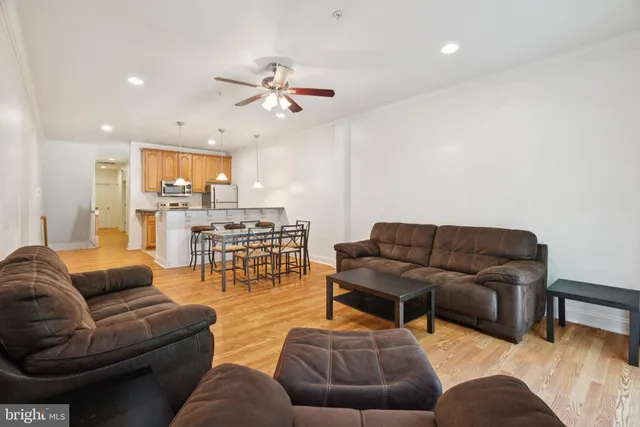 a living room with furniture and kitchen view