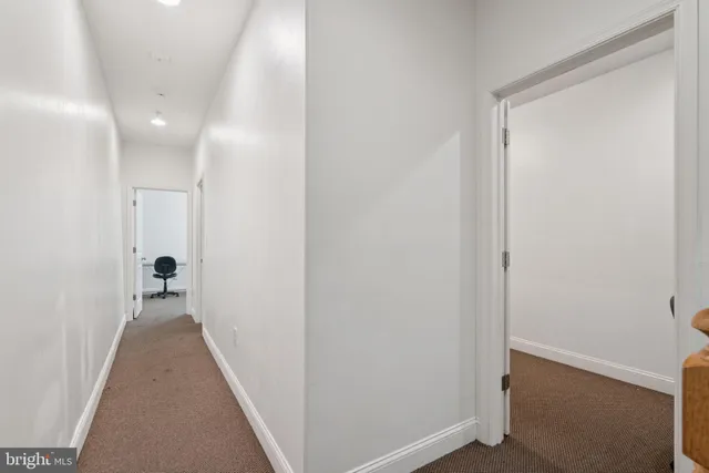 a bathroom with a granite countertop sink and a toilet
