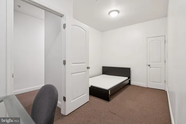 a bedroom with a bed and a chair