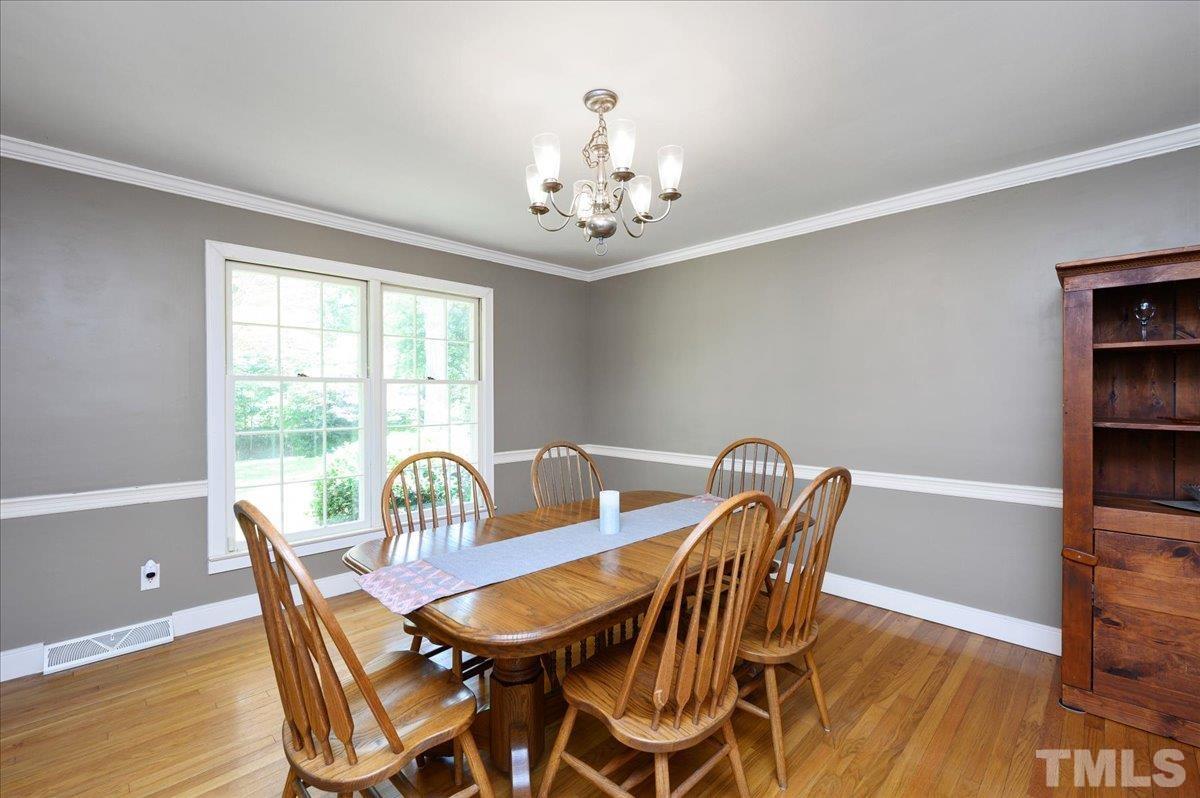 8824 Oneal Road Raleigh, NC 27613 - Photo 12 of 33 a view of a dining room with furniture window and outside view
