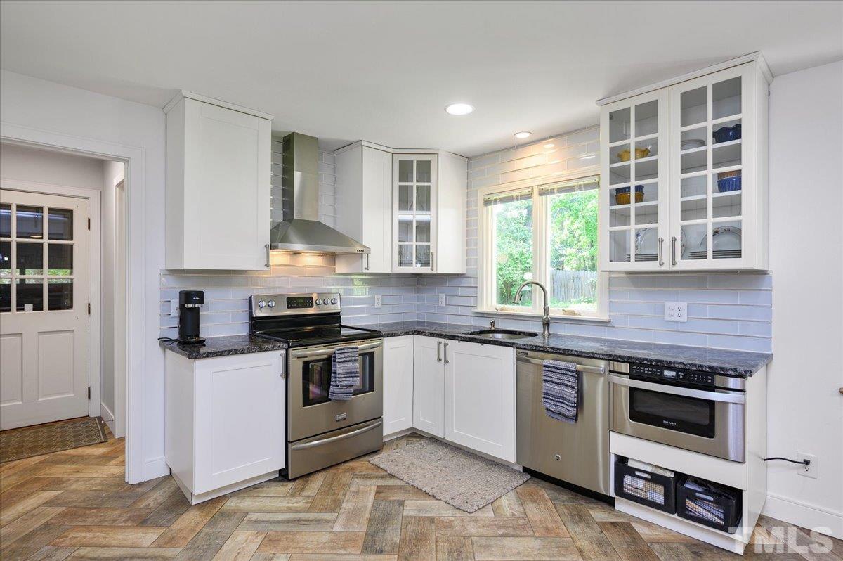 8824 Oneal Road Raleigh, NC 27613 - Photo 16 of 33 a kitchen with stainless steel appliances granite countertop a stove and a sink