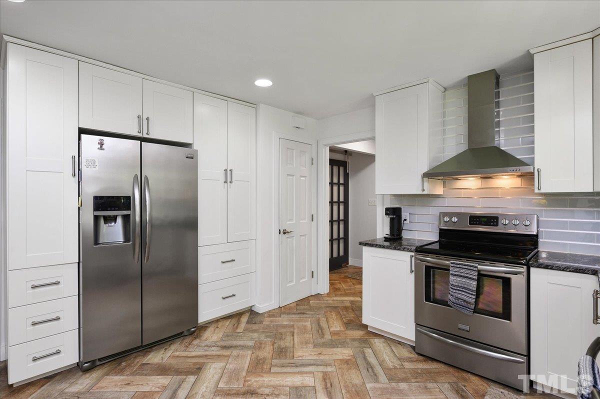 8824 Oneal Road Raleigh, NC 27613 - Photo 17 of 33 a kitchen with granite countertop a refrigerator and a stove
