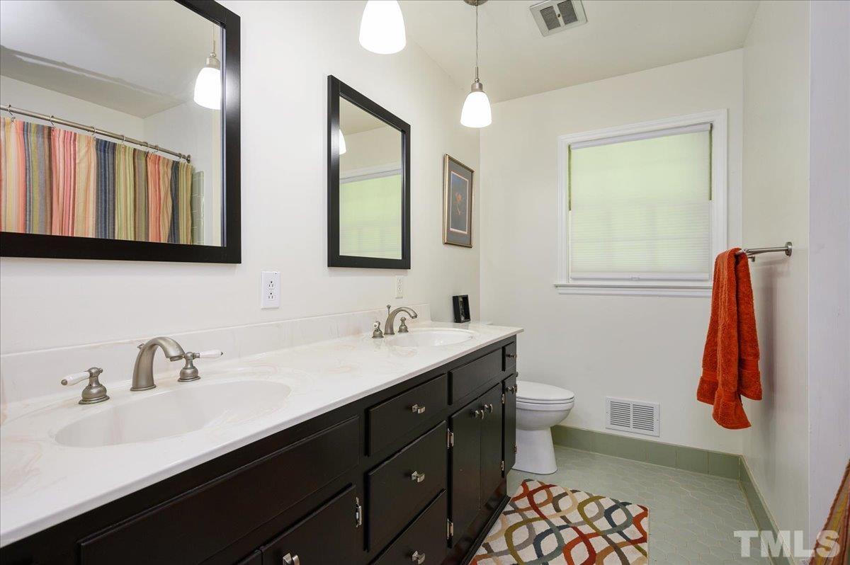 8824 Oneal Road Raleigh, NC 27613 - Photo 28 of 33 a bathroom with a sink and a mirror