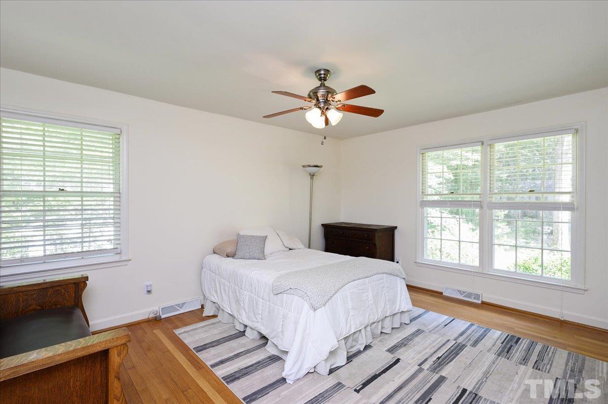 8824 Oneal Road Raleigh, NC 27613 - Photo 29 of 33 a bedroom with a large bed and a window
