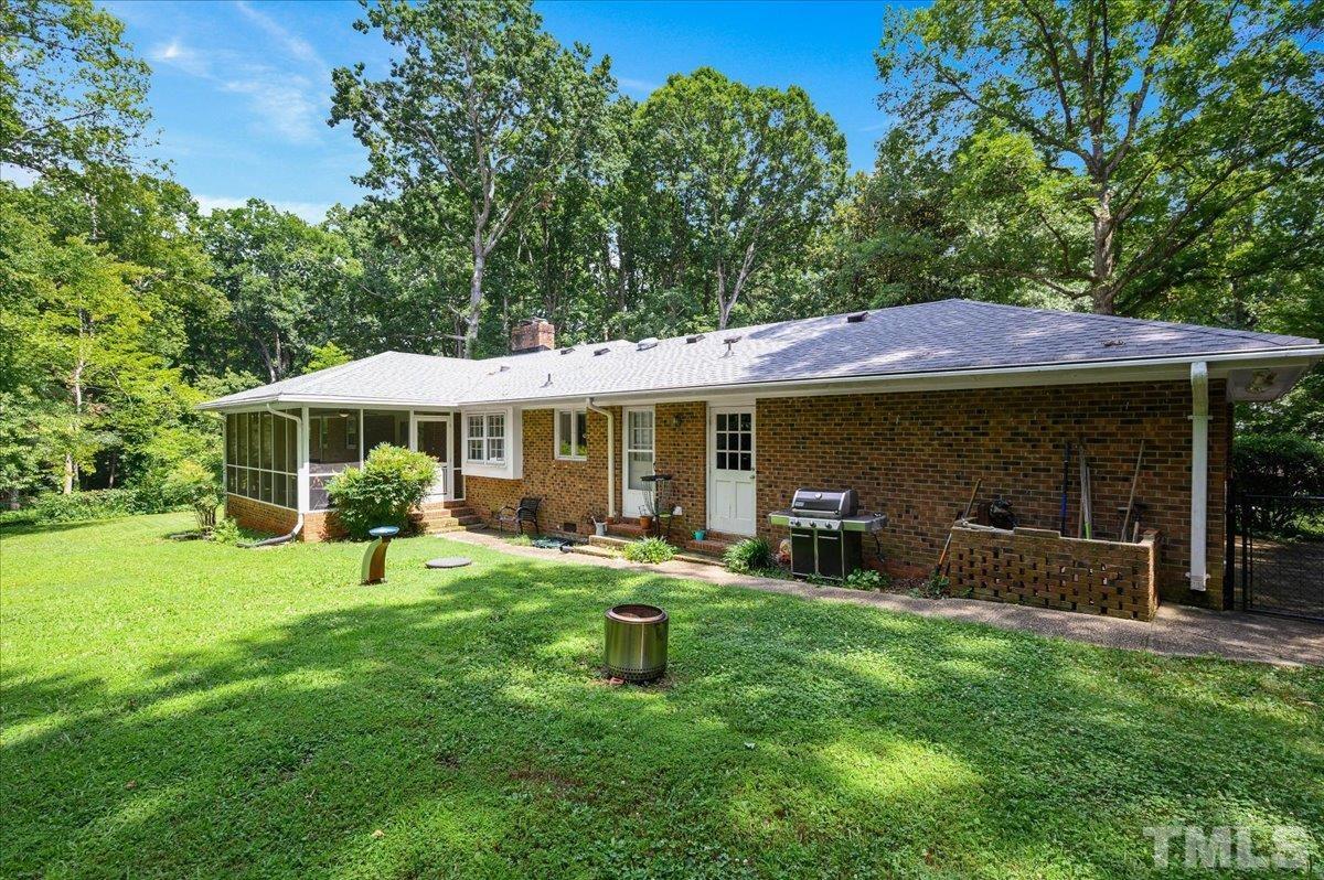 8824 Oneal Road Raleigh, NC 27613 - Photo 5 of 33 a patio with a table and chairs under an umbrella