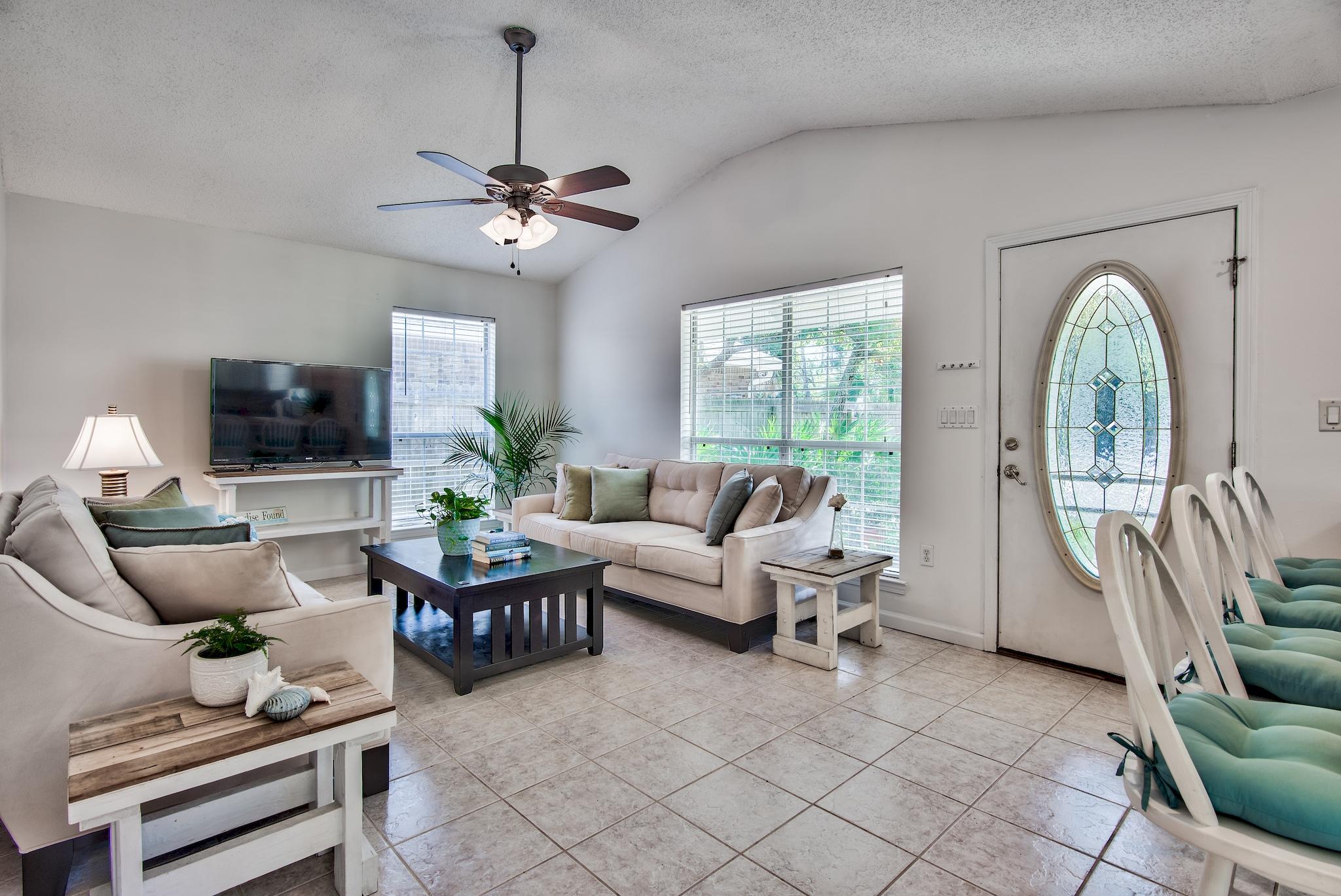 105 Ash Street Santa Rosa Beach, FL 32459 - Photo 7 of 43 a living room with furniture a chandelier fan and a window
