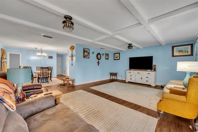a bedroom with furniture and a flat screen tv