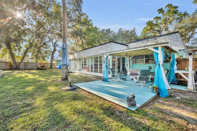 a view of a house with a yard patio and swimming pool