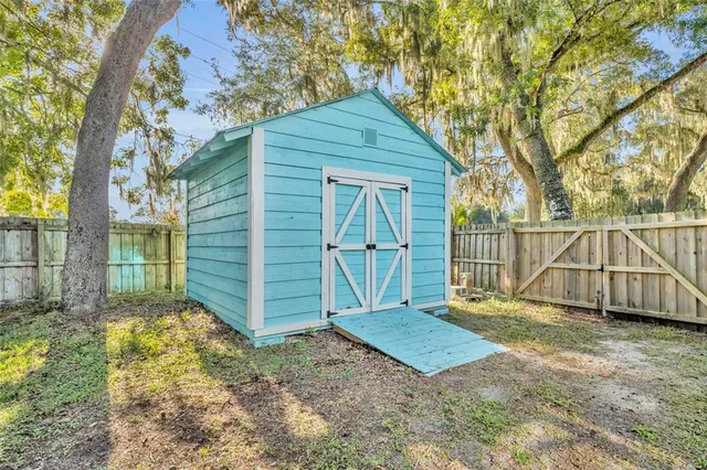 a view of backyard with small cabin