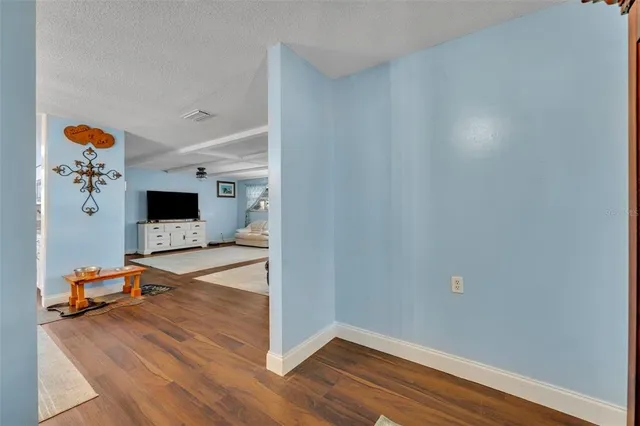 a view of a livingroom with wooden floor and a flat screen tv