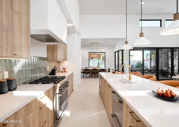 a large white kitchen with a large window