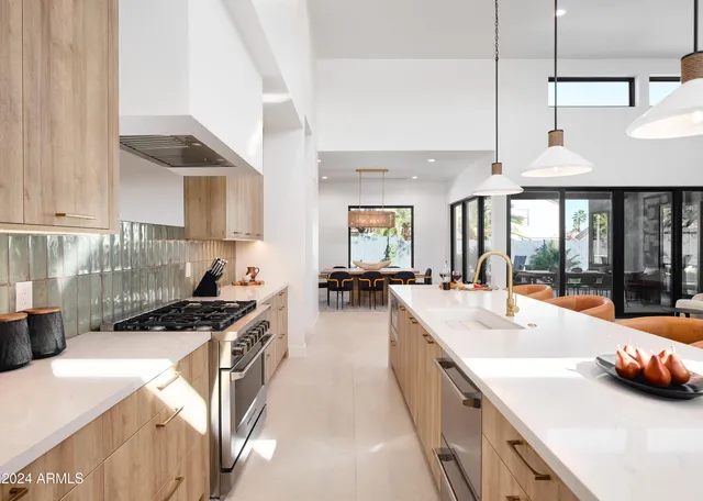 a large white kitchen with a large window