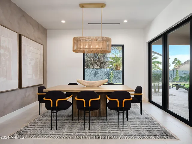 a view of a dining room with furniture wooden floor and chandelier