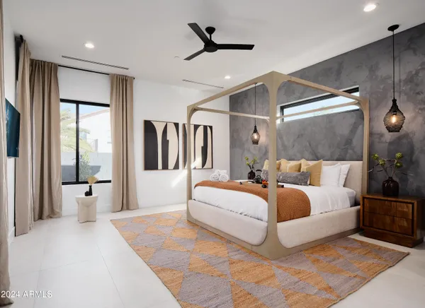 a spacious bedroom with a large bed and a chandelier