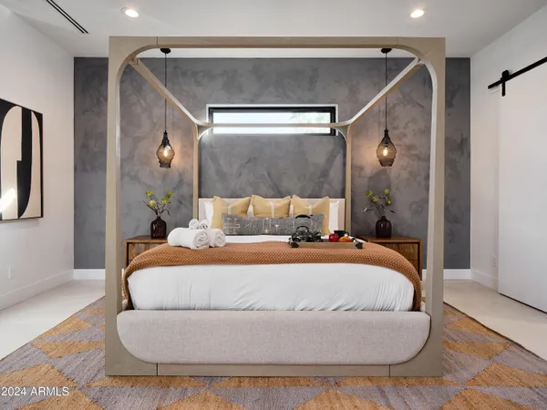 a bedroom with a bed and a mirror