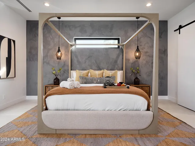a bedroom with a bed and a mirror