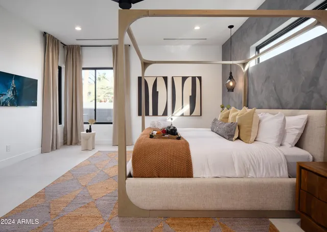 a bedroom with a bed and a couch