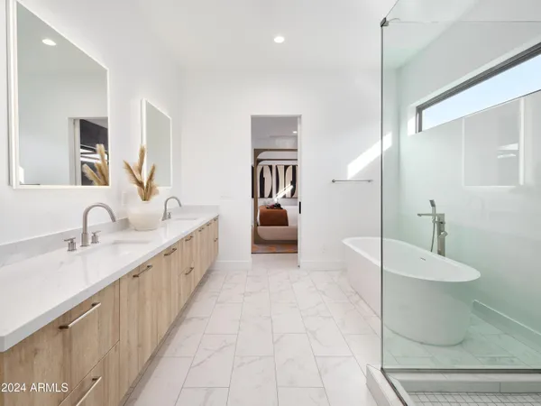 a bathroom with a double vanity sink a mirror and a toilet