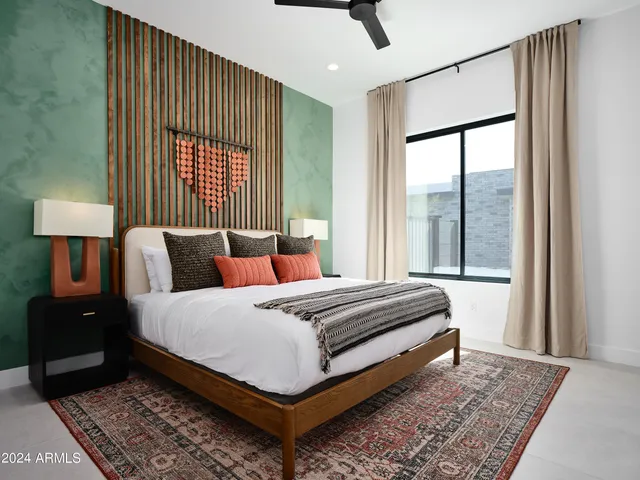 a bedroom with a bed lamp and a window