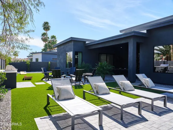 a view of a patio with couches table and chairs with plants