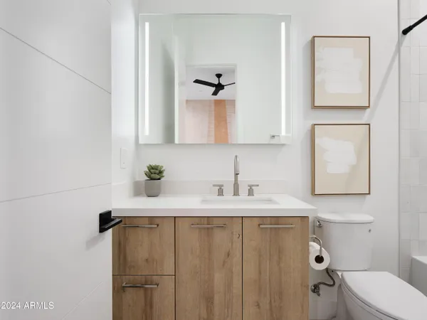 a bathroom with a sink toilet and mirror