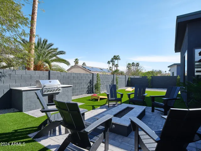 a view of a chairs and table in patio with a fire pit