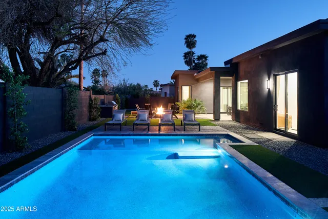 a view of a swimming pool with an outdoor seating