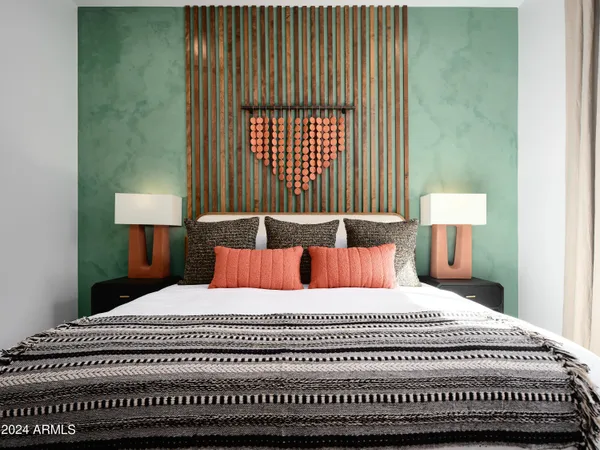 a bedroom with a large bed and a window